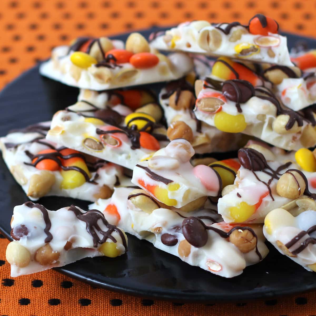 Candy Corn chocolate bark filled with peanuts, caramel, and Reese's Pieces.