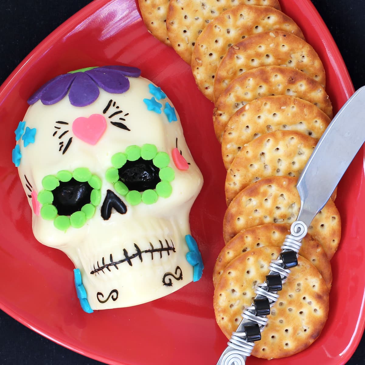 sugar skull made of white cheese and colorful cheese decorations.