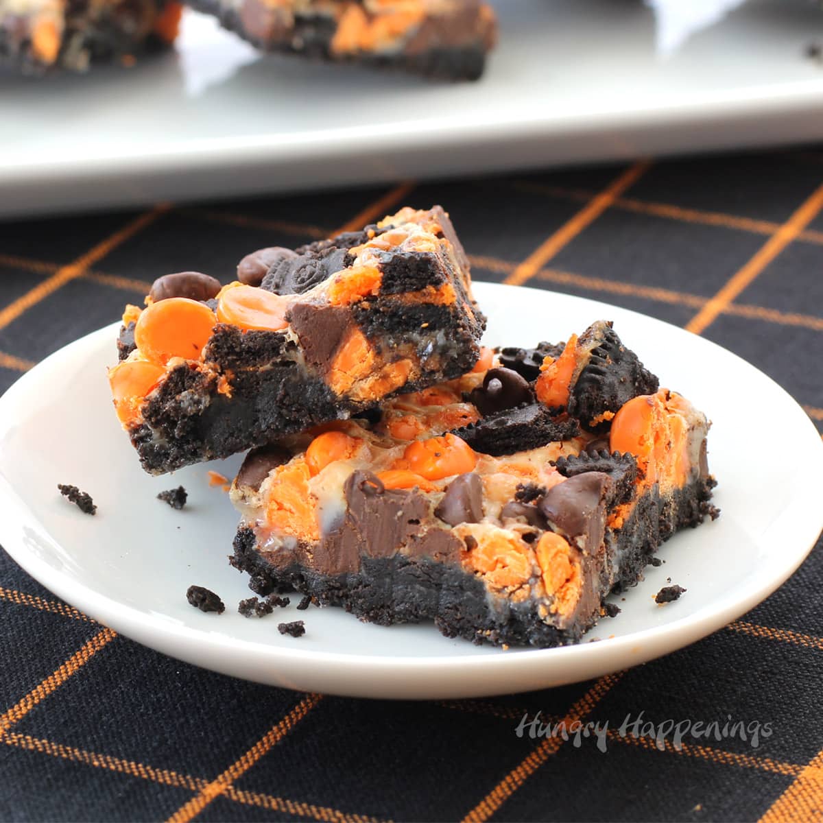 Halloween magic bars with an OREO Cookie crust, caramel, chocolate chips, orange chips, and cookie pieces.