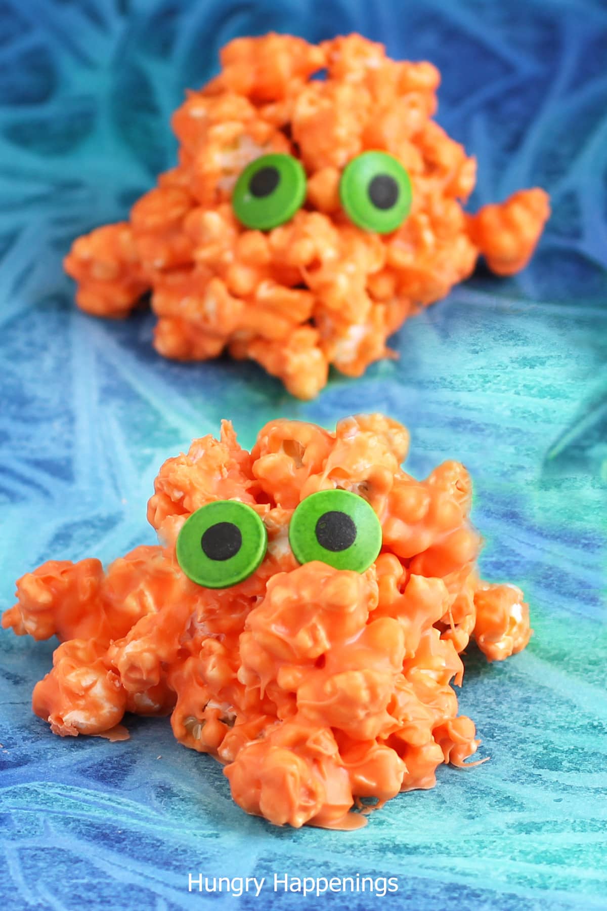 Halloween popcorn monsters made with orange popcorn. 