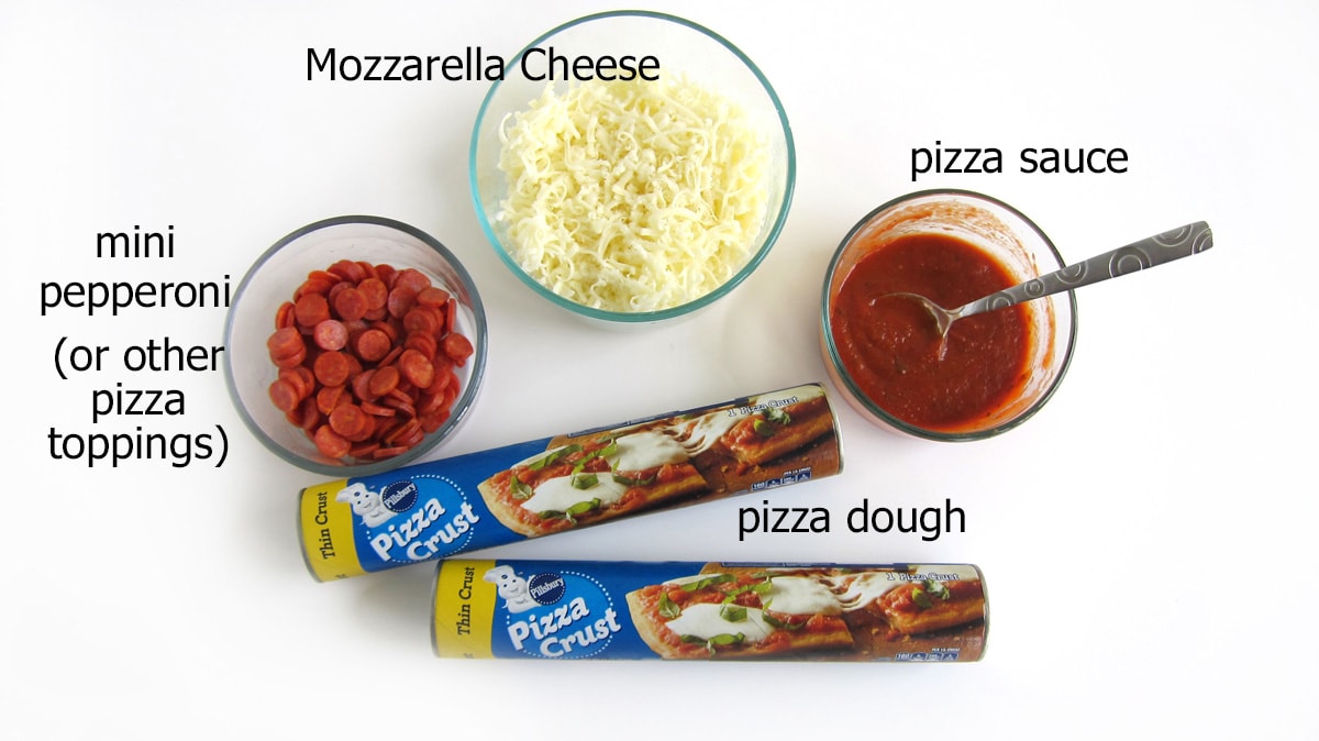 pizza skull ingredients including pizza dough, pizza sauce, Mozzarella cheese, and toppings like mini pepperoni. 