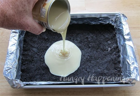pour sweetened condensed milk over the OREO Cookie crust