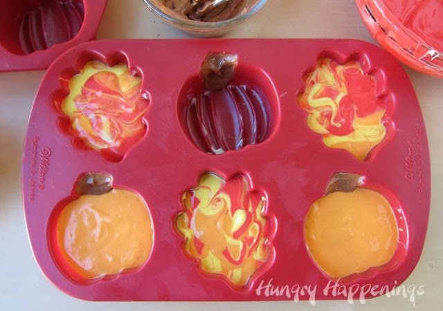 silicone leaf and pumpkin mold filled with colored cake batter. 