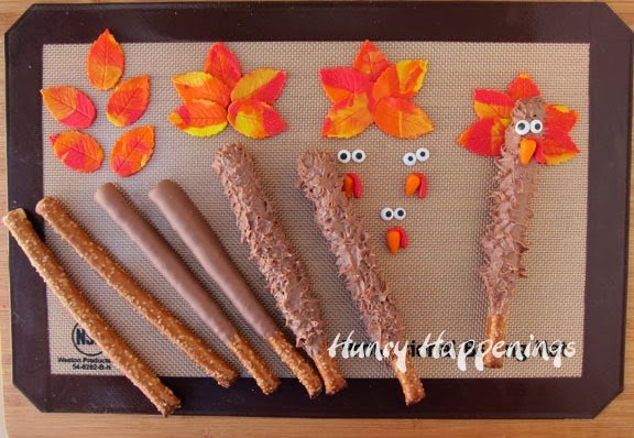 decorating chocolate dipped pretzel rods to look like turkeys using modeling chocolate feathers, beaks, and wattles. 