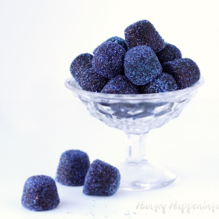Homemade blueberry gumdrops in a clear candy dish.