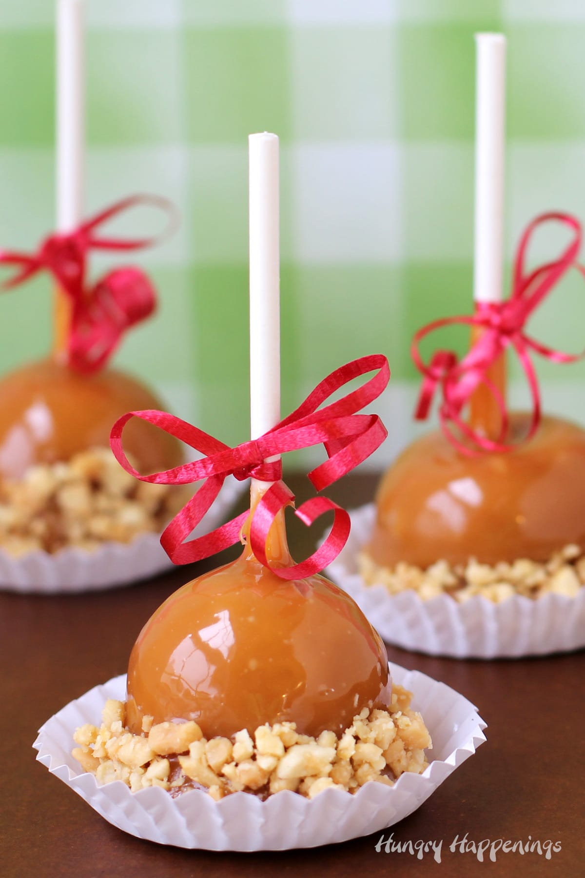 mini caramel apples made with caramel apple fudge dipped in caramel and rolled in chopped peanuts. 