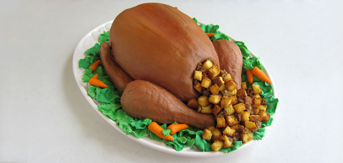 whole roasted turkey cake on a platter of fondant lettuce and carrots 