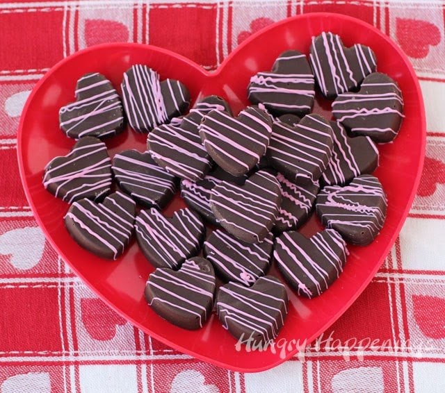 cherry cordial fudge arranged on a red heart dinner plate set on a Valentine's Day tablecloth
