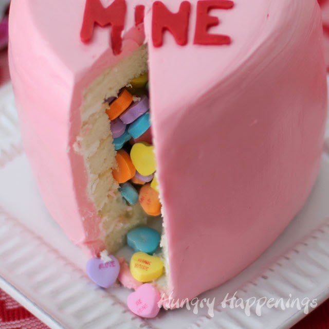 closeup of a Valentine's Day Conversation Heart Pinata Cake with conversation heart candies inside