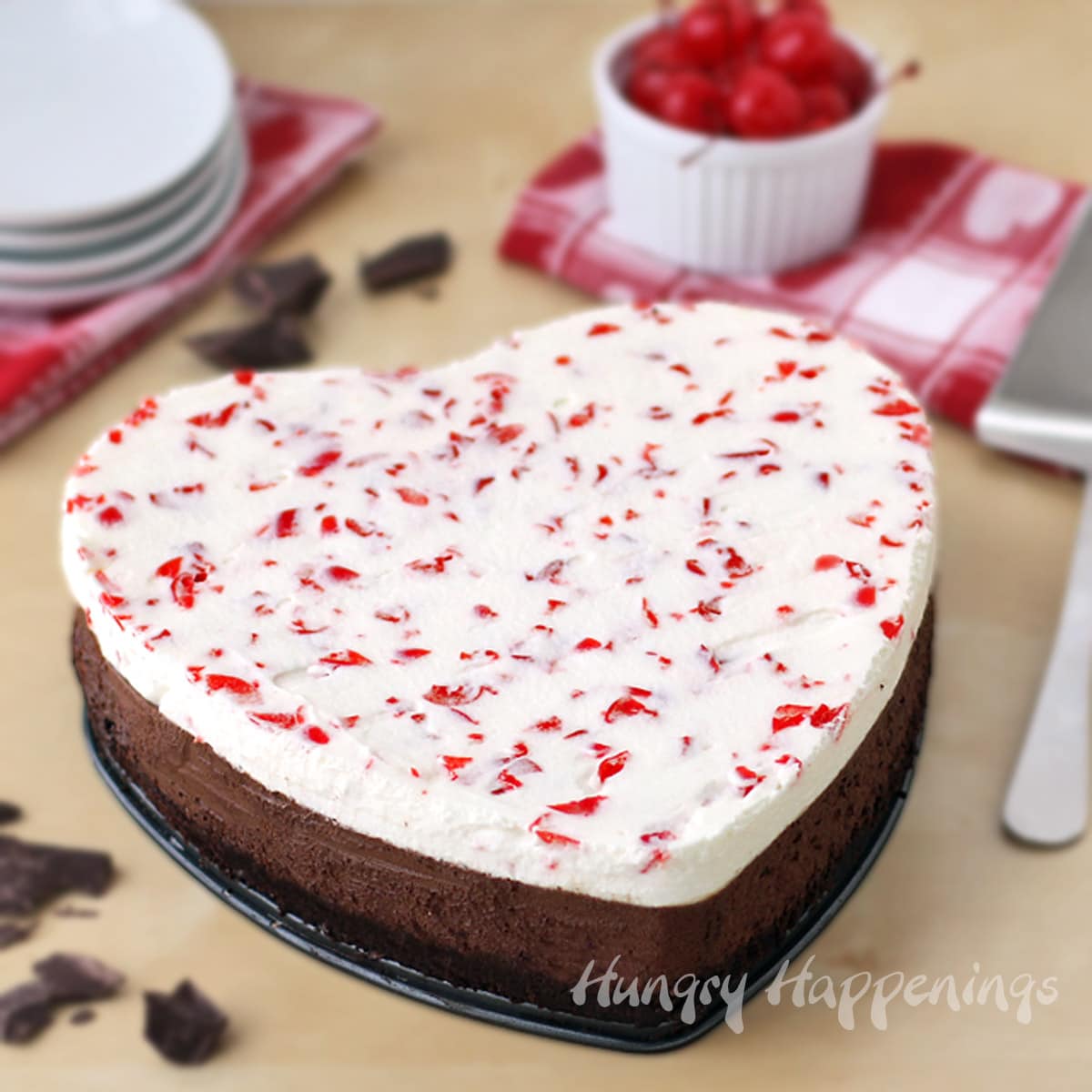 heart-shaped chocolate cherry mousse cake topped with maraschino cherries