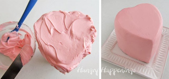 frosting a heart cake with pink frosting