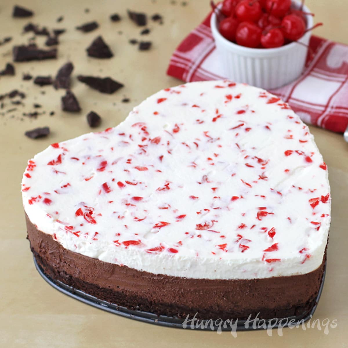 Valentine's Day triple chocolate cherry mousse cake with a flourless chocolate cake crust, chocolate mousse layer, and a white chocolate cherry mousse layer.