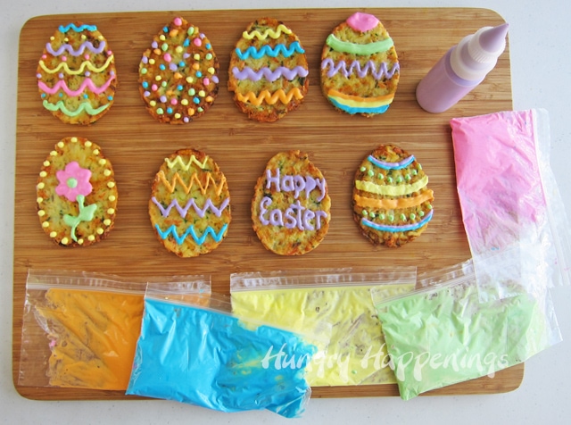 decorating Easter egg-shaped potato pancakes with colored sour cream.