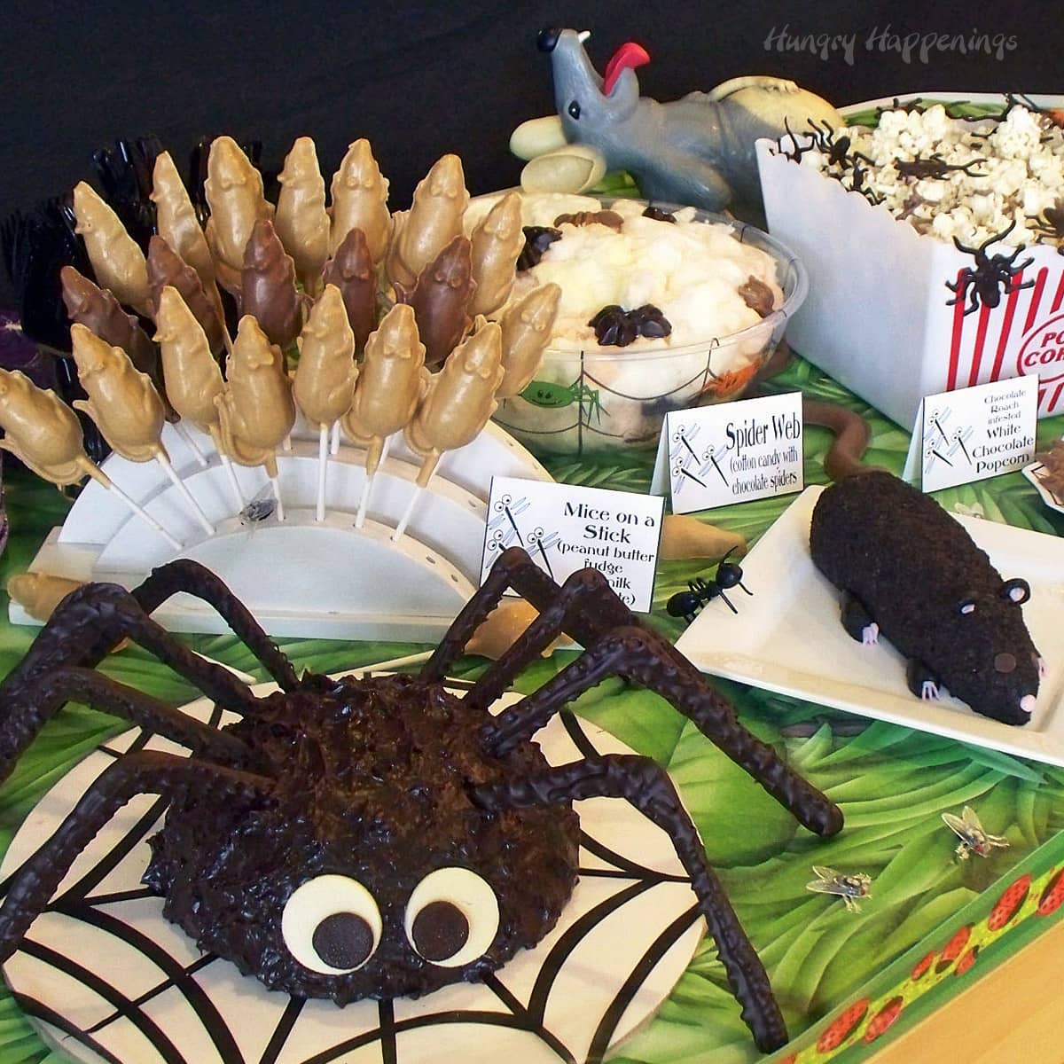 bug-themed party food with a giant spider cake, a cheese ball rat, chocolate roaches, and more. 