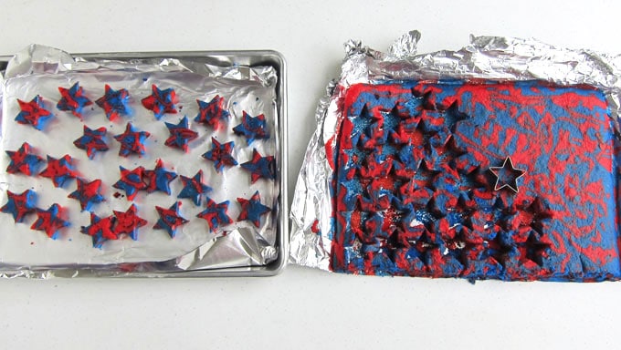 cut small stars out of the tie-dye red and blue cake using cookie cutters