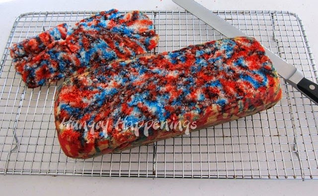 Red, white and blue tye-dye cake with the top cut off. 