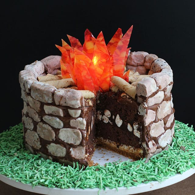 fire pit s'mores cake cut showing brownie, marshmallows, and chocolate frosting