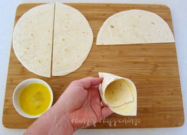 Cut a tortilla in half and roll it into a cone.