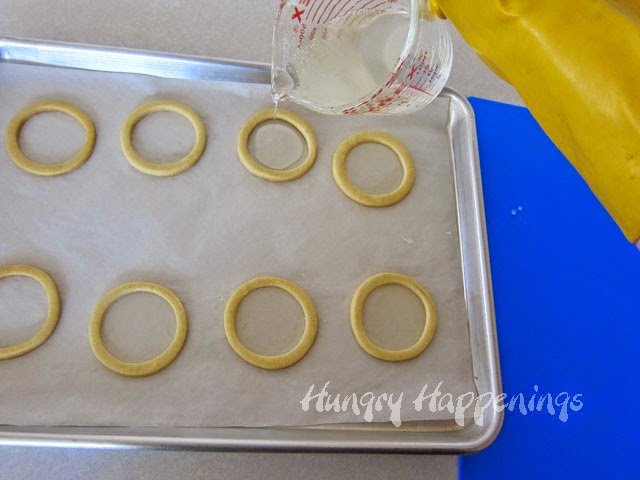 pouring hot isomalt into cookie rings. 