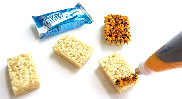 Pipe orange and black frosting fur onto the rice krispie treats to make furry monsters.