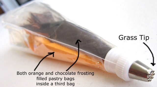 place one pastry bag of orange frosting and one pastry bag of black frosting into another pastry bag then attach a grass pastry tip