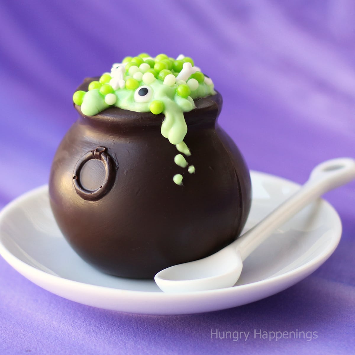 chocolate cauldrons filled with green pudding and magical mix-ins including candy eyes, bone sprinkles, and green sugar pearls.
