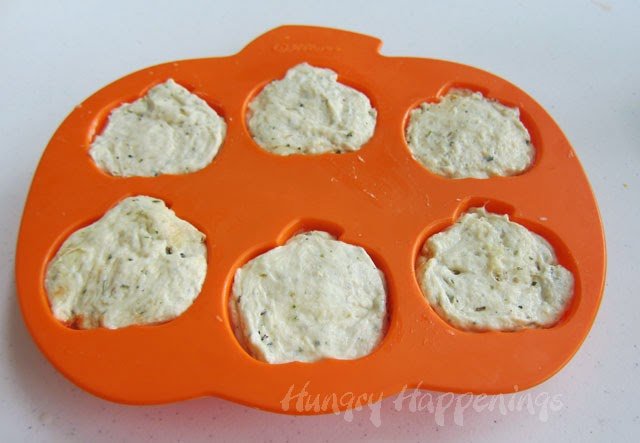 silicone pumpkin mold filled with Italian herb pizza dough. 