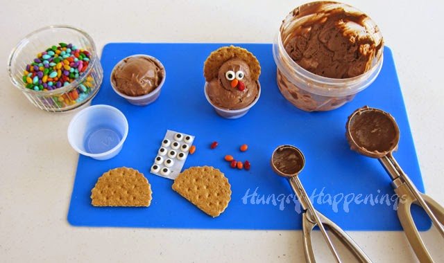 making cocoa banana ice cream turkeys using graham crackers, candy eyes, and candy-coated sunflower seeds. 