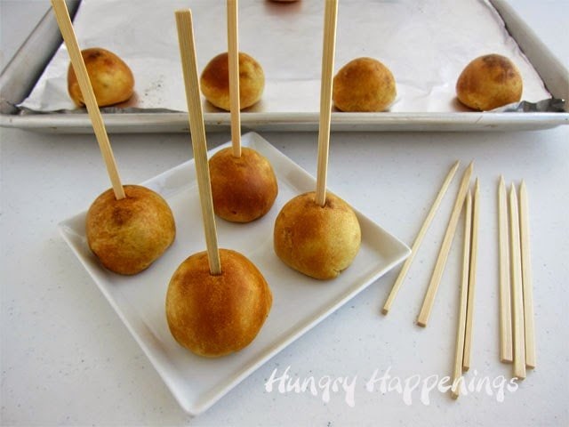 skewers inserted into pizza dough-wrapped meatballs
