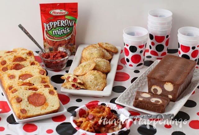 polka dot party table filled with pepperoni bread, fried pepperoni won tons, and a polka dot semifreddo dessert. 