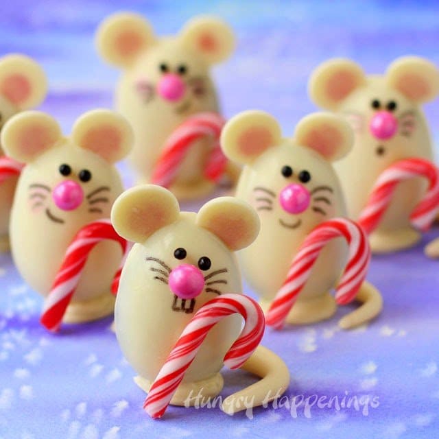 Mouse chocolates holding candy canes.
