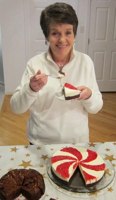 Mom enjoying a slice of White Chocolate Peppermint Mousse Cake at our holiday party. | HungryHappenings.com