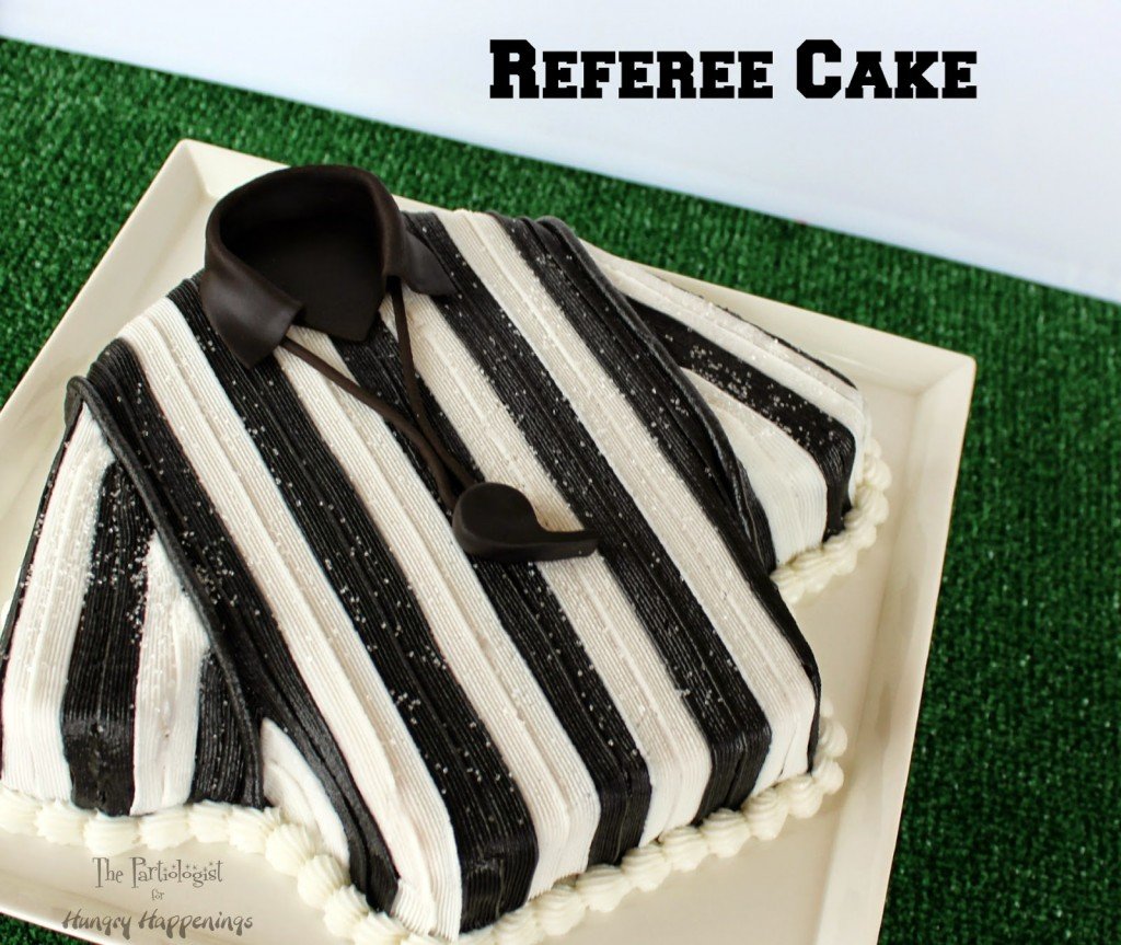 Referee Cake on a white platter set on green astro turf