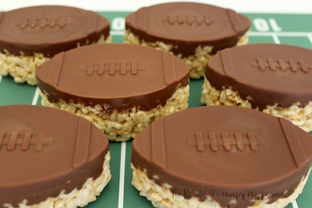 It's wouldn't be a Super Bowl party without them. Hi, it's Kim, The Partiologist back with another game day favorite. I don't think I've ever been to a super bowl party with out seeing a rice krispie treat and these Chocolate Topped Rice Krispie Treat Footballs are so simple and impressive! You can have them ready before kick off!