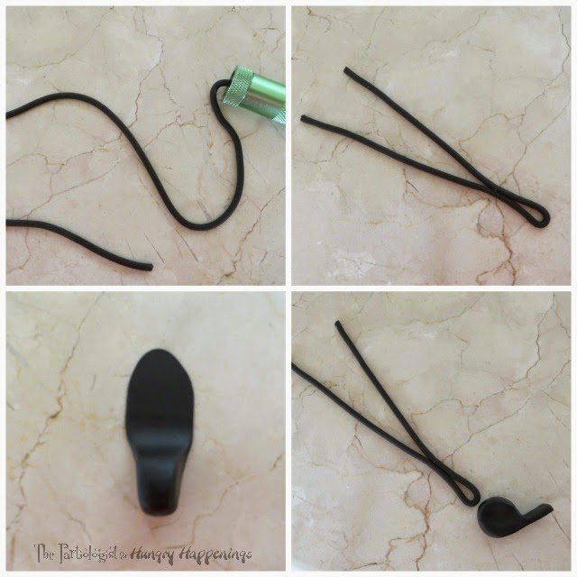 pipe black fondant into a thin rope then attach it to a fondant whistle