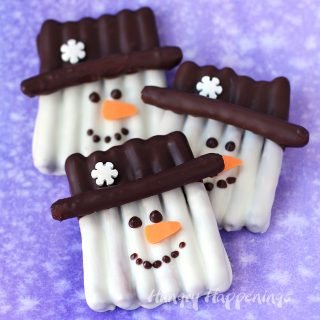 This winter get crafty in the kitchen by making some sweet and salty snowmen pretzels. Each Chocolate Pretzel Snowman Craft couldn't be cuter with their orange carrot noses and snowflake topped hats. They make perfect Christmas treats and wintertime snacks.