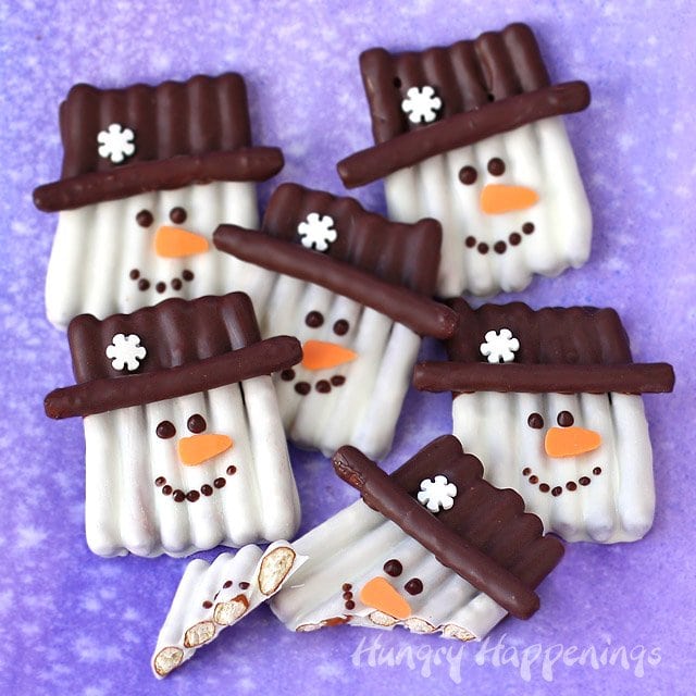 This winter, get crafty in the kitchen by making some sweet and salty snowmen pretzels. Each Chocolate Pretzel Snowman Craft couldn't be cuter with their orange carrot noses and snowflake topped hats. They make perfect Christmas treats and wintertime snacks.