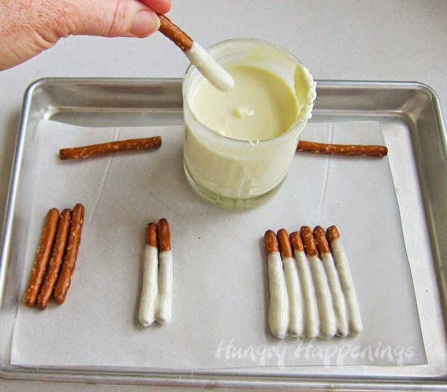 How to dip pretzels in white chocolate to make snowman pretzels.