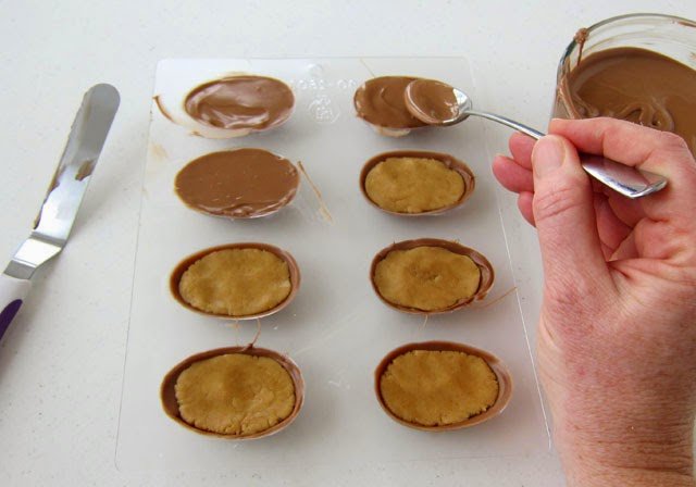 How to make chocolate eggs filled with peanut butter fudge. Recipe and tutorial from HungryHappenings.com
