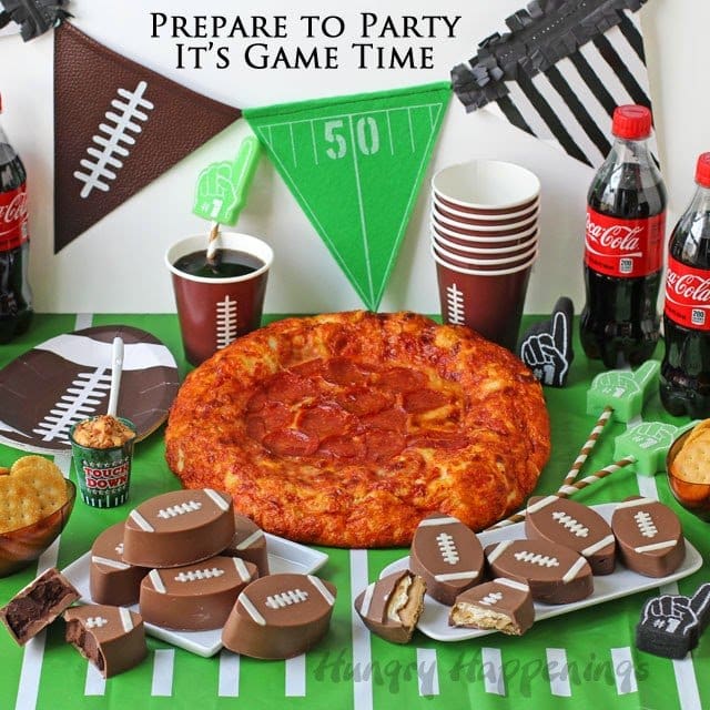 football party food table with a pizza and chocolate footballs