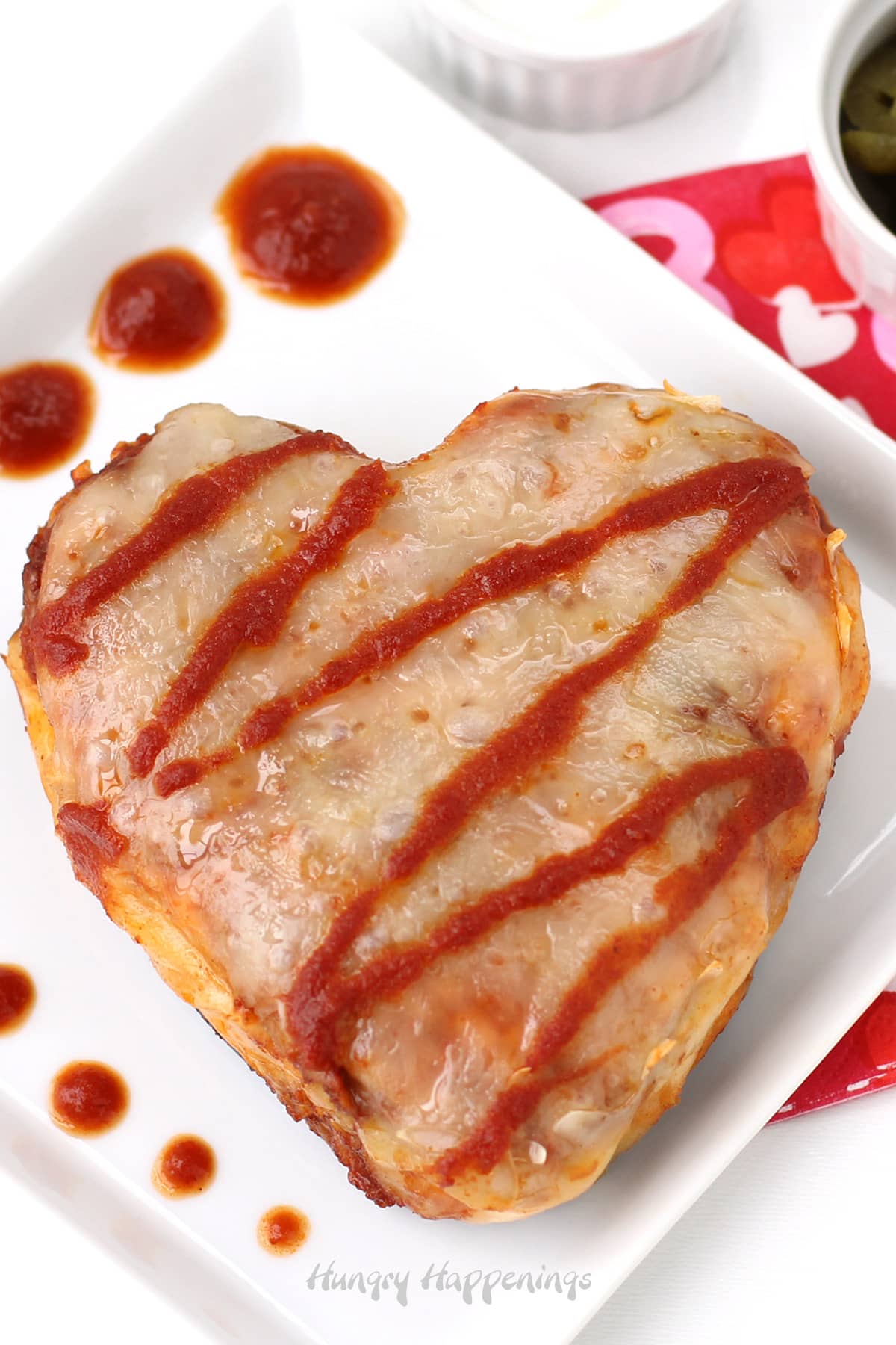 chicken enchilda hearts drizzled with red chili sauce