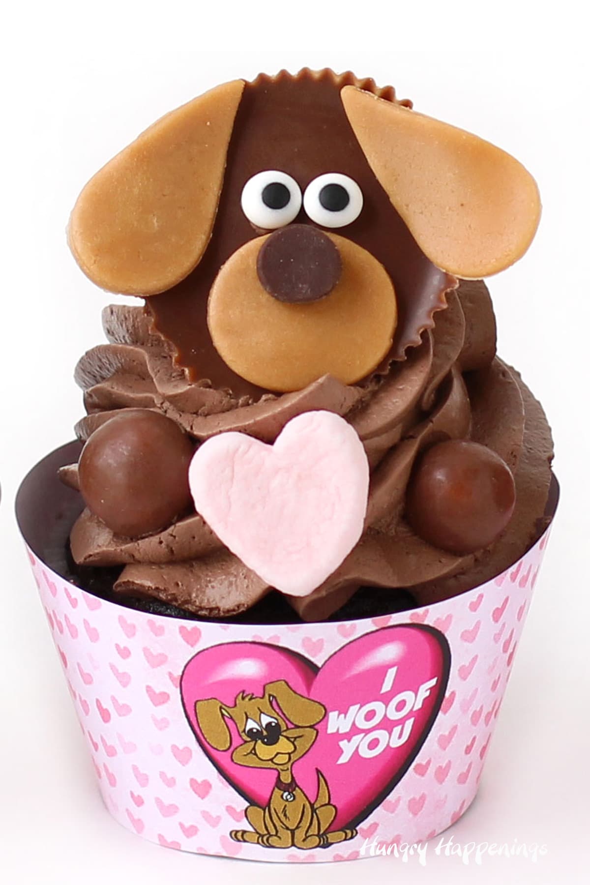 Cute chocolate puppy dog cupcakes with Reese's Cup dog decorated with caramel and candy eyes. 