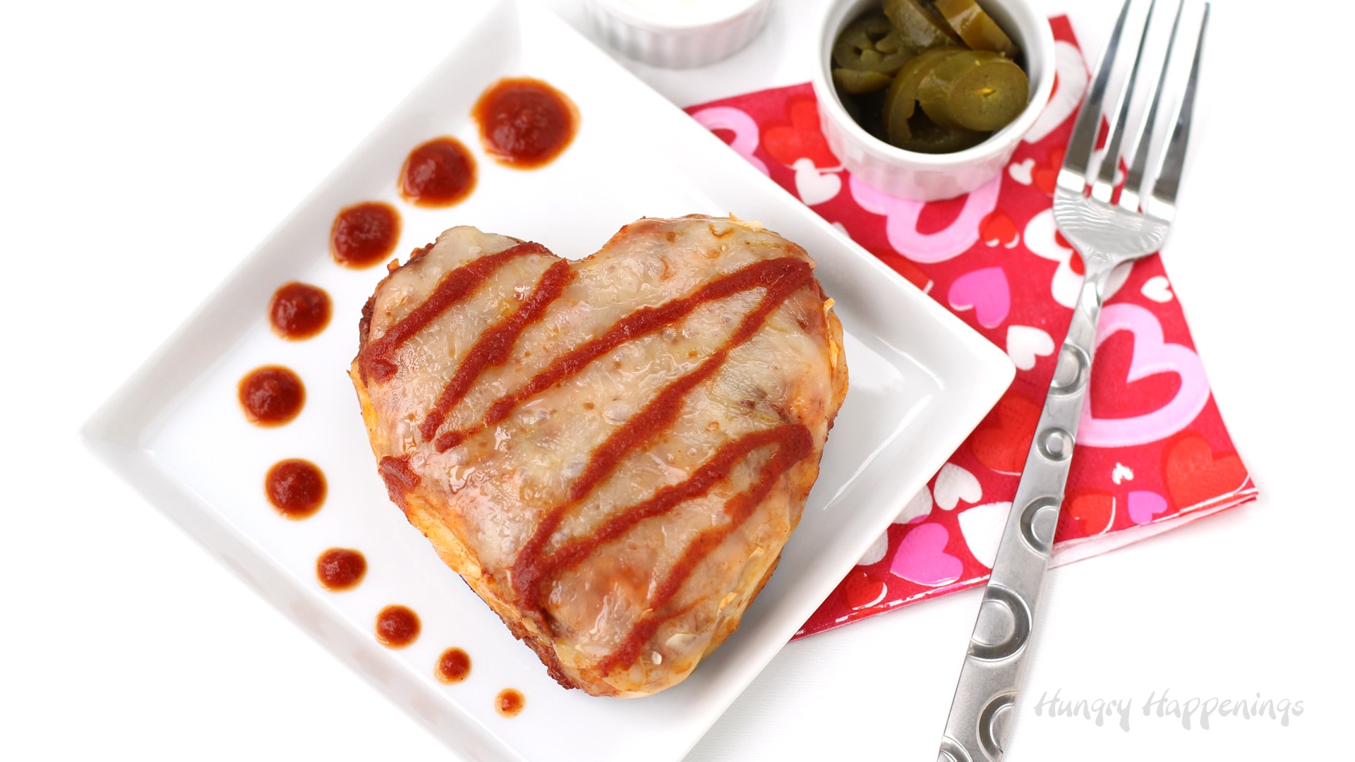 Valentine's Day dinner recipe - chicken and cheese enchilada hearts served with jalapenos, sour cream, and chili sauce