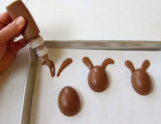 How to make handmade peanut butter fudge filled chocolate Easter egg bunnies. Tutorial at HungryHappenings.com