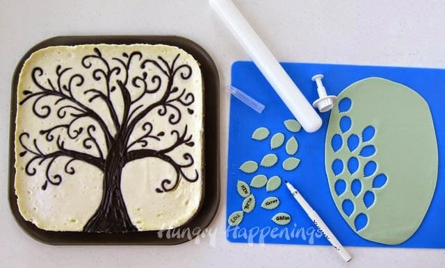 cutting modeling chocolate leaves using a plunger cutter and adding names using a food coloring marker