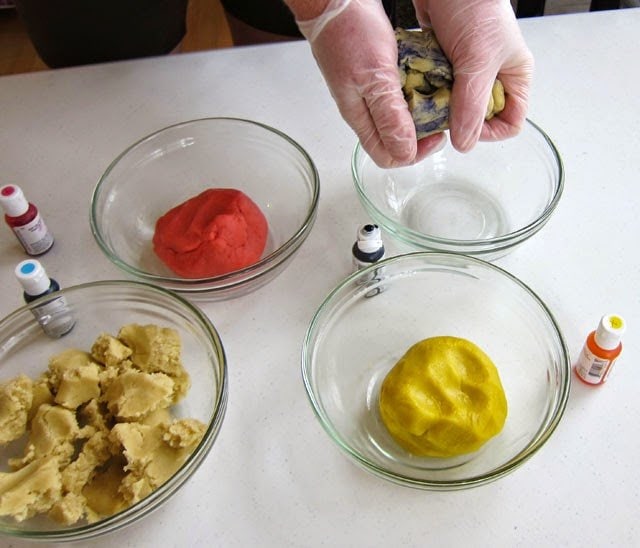 coloring sugar cookie dough pink, yellow, and blue using gel food coloring