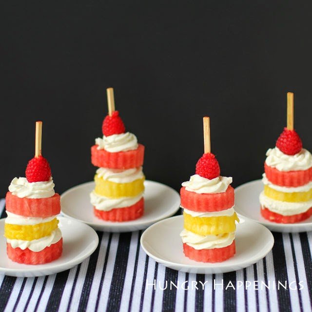 mini watermelon and pineapple cakes with whipped cream and a raspberry