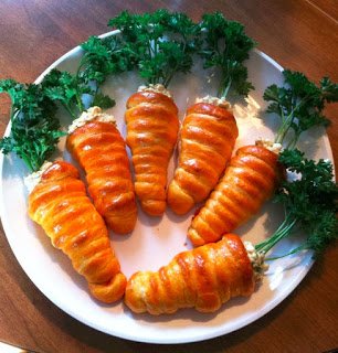 carrot crescent rolls served o a white dinner plate. 
