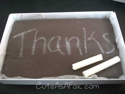 chocolate chalkboard with "thanks" written with white chocolate chalk. 