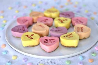 conversation heart cheesecakes on a round white plate. 